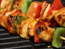 Tired of the standard BBQ fare? Try our juicy grilled chicken skewers with bell peppers and onions, showcasing the appealing char marks from the grill.