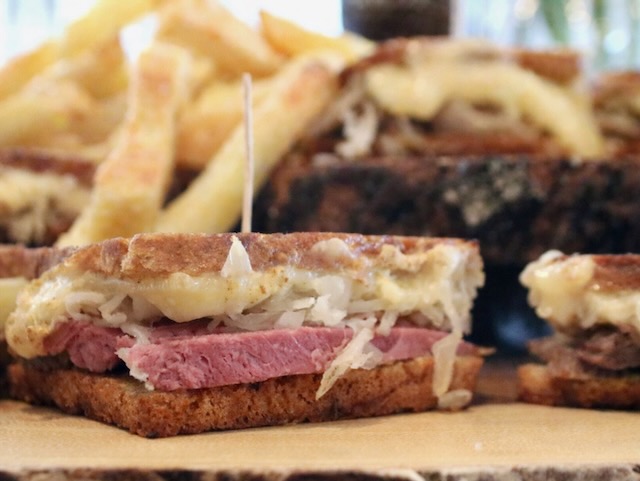 The best Corned beef recipe used to make mini Ruben Sandwiches on a platter with fries