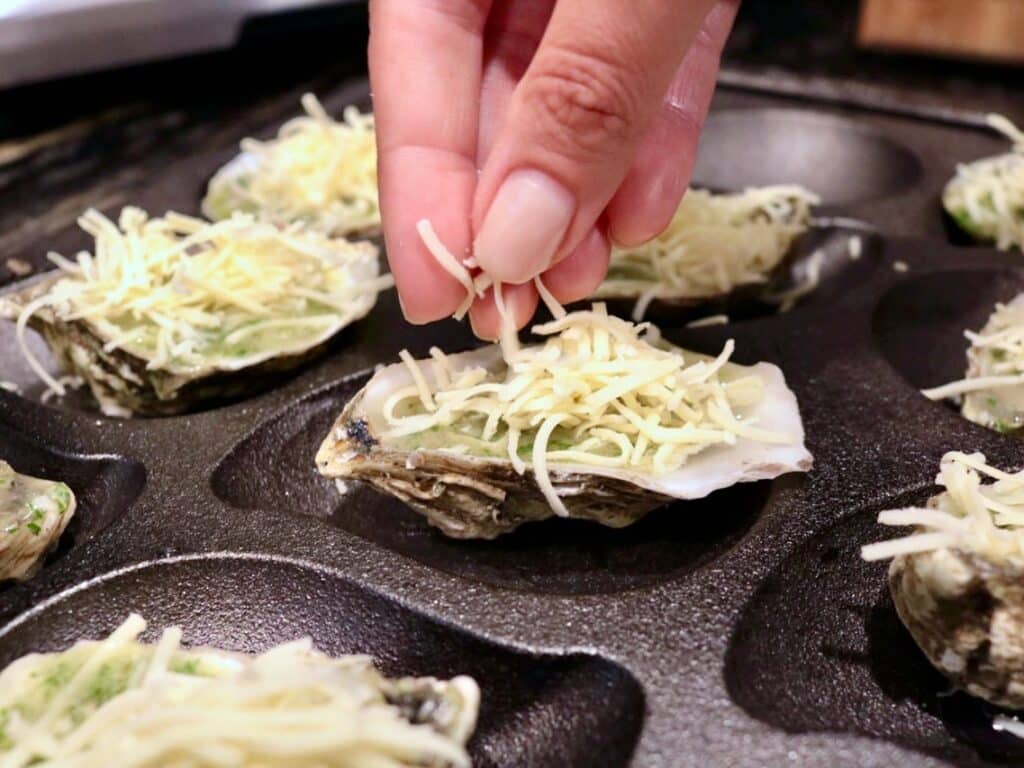 Preparing Roasted Oysters with cheese