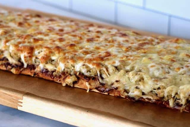 cooked flatbread layered with cranberry sauce, shredded turkey, stuffing & melted cheese