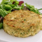 crab cake from crab cake recipe with a green salad on the side