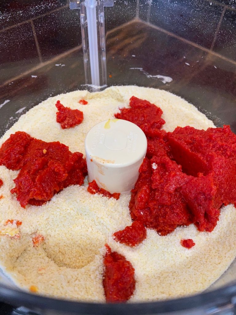 Flour in a food processor with red pepper puree