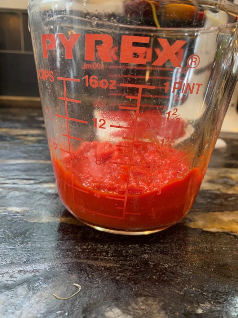 Red pepper puree in a measuring cup