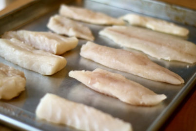Pieces of fish on a sheet pan