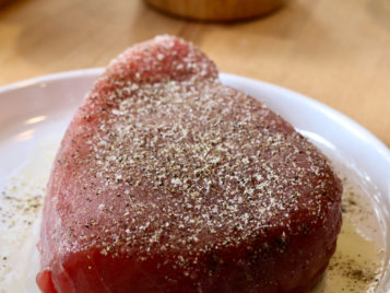 raw tuna steak with salt and pepper