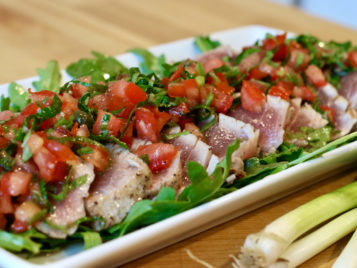 Grilled tuna on platter with tomatoes & capers