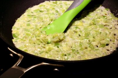 Leeks and butter cooking in pan