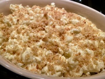 Cauliflower with cheese sauce and breadcrumbs before baking