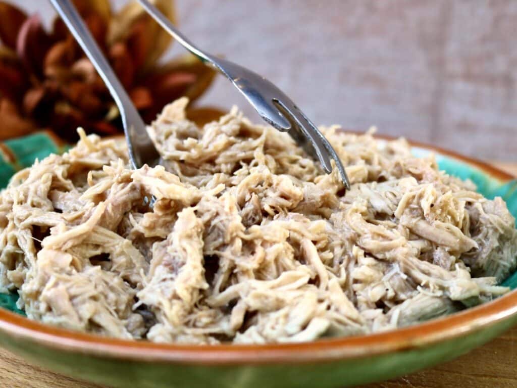 Slow Cooker Shredded Turkey smothered in in gravy in a serving bowl
