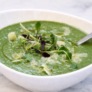 homemade broccoli soup recipe in a white bowl with garnish