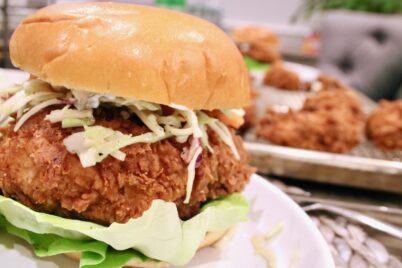 Fried Chicken Sandwich with coleslaw, butter leaf lettuce on a golden potato roll