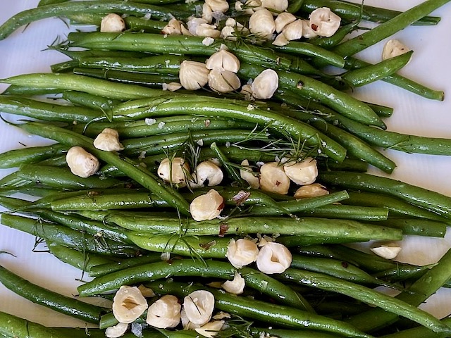 French Beans on a platter with toasted hazelnuts and Dill garnish