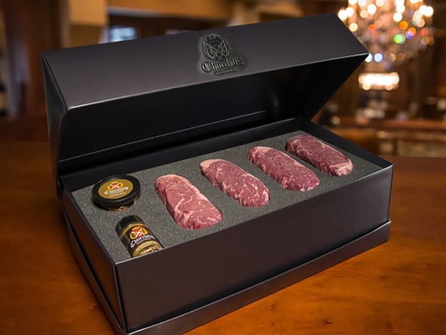 Churchills New York Strip prime steak gift box in luxury black box showcasing 4 steaks, steak seasoning and steak butter