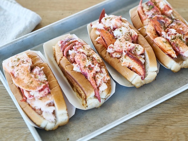 4 lobster rolls on a serving tray