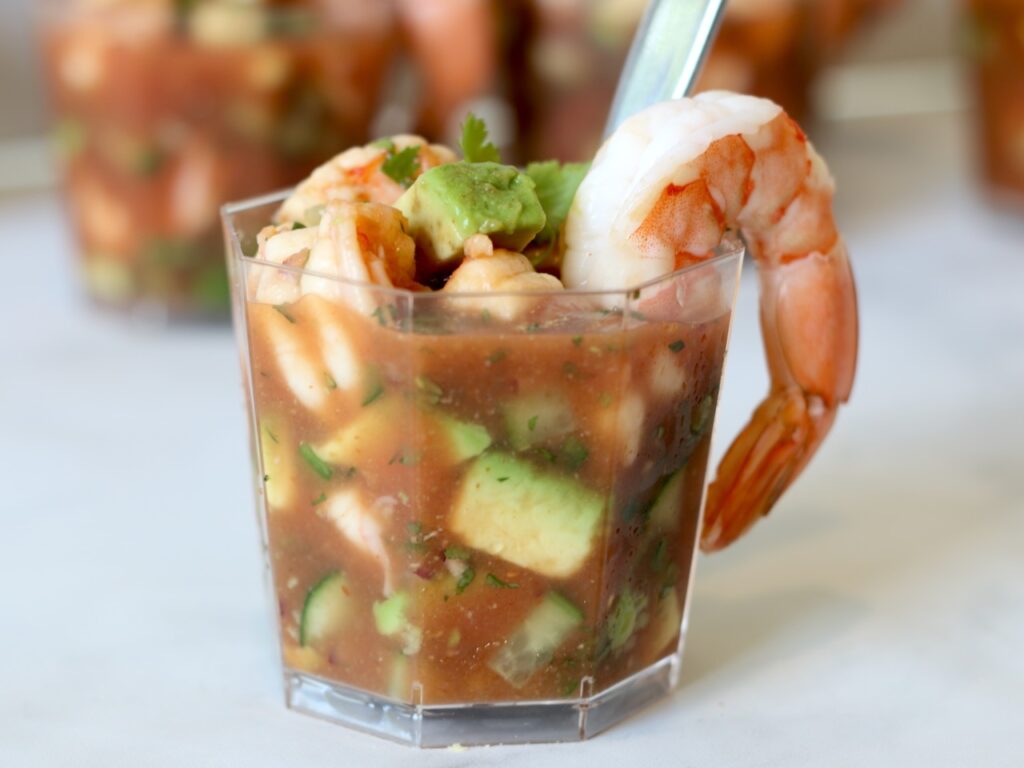 Individual portion of Mexican shrimp cocktail in a clear serving cup