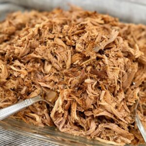 Slow Cooker Pulled Pork in a casserole dish after being shredded