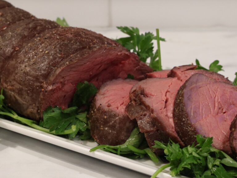slow-roasted-beef-tenderloin cooked perfectly medium rare and sliced on a platter