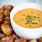 Homemade beer cheese dip served with warm pretzel nuggets