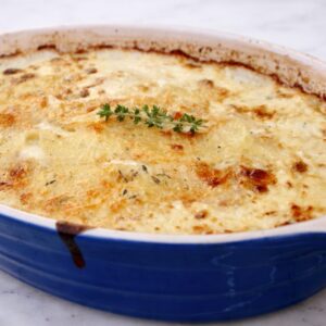 scalloped potatoes au gratin in a le cruset baking dish