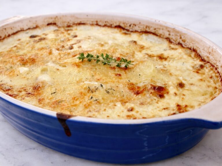 scalloped potatoes au gratin in a le cruset baking dish