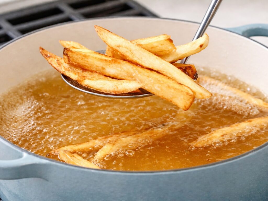 Traditional English chips in fryer