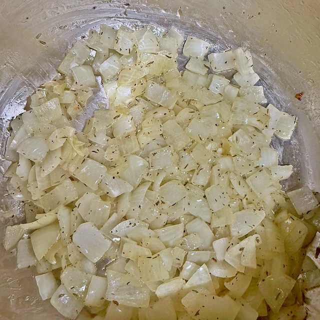 Diced onions sautéed low and slow with thyme, the first step for immune boosting mushroom soup