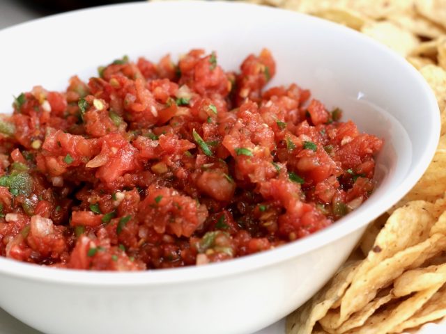 Homemade salsa in a bowl with tortilla chips