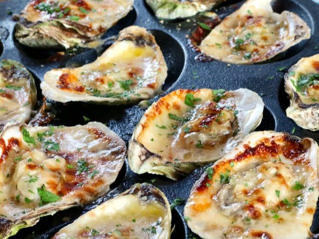 roasted oysters in a cast iron tray
