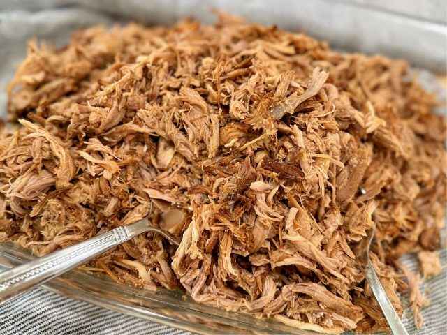 Slow Cooker Pulled Pork in a casserole dish after being shredded