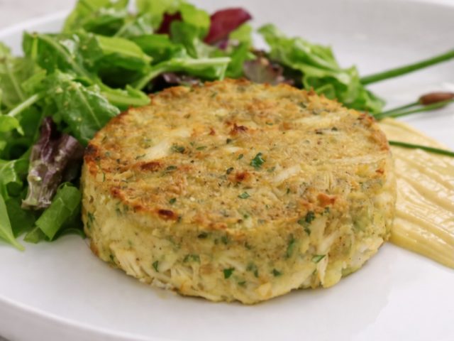 crab cake from crab cake recipe with a green salad on the side