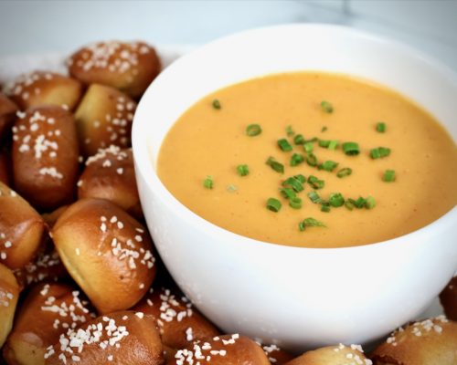 Homemade beer cheese dip served with warm pretzel nuggets