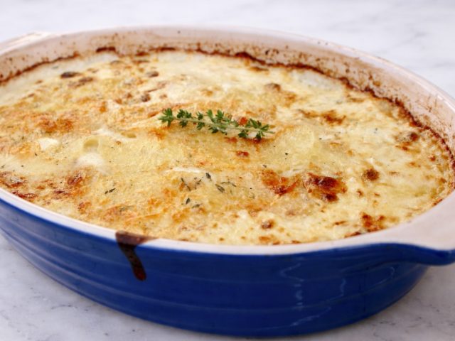 scalloped potatoes au gratin in a le cruset baking dish