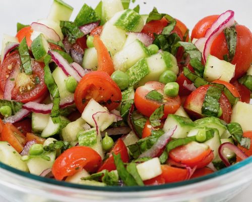 summer tomato cucumber basil salad with fresh peas, and herbs