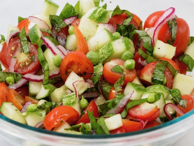 summer tomato cucumber basil salad with fresh peas, and herbs